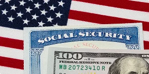 American flag, social security card, and a $100 bill representing social security