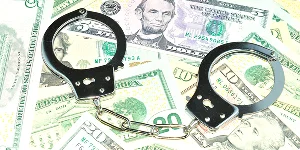 Handcuffs placed next to stacks of cash on a white background, symbolizing crime or illegal activities.
