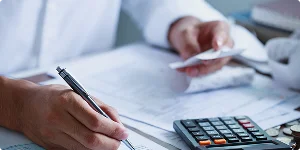 A person calculating balances or taxes, representing accounting services