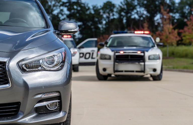 Two police vehicles stop a sedan