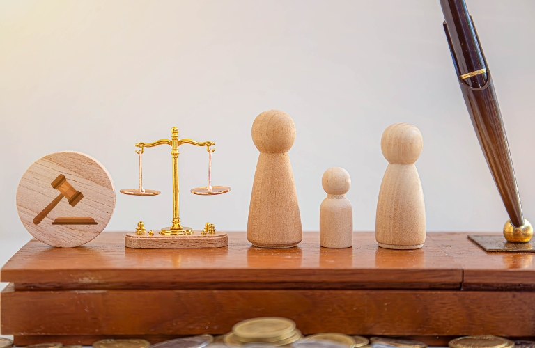 wooden family figures, judge and scales of justice