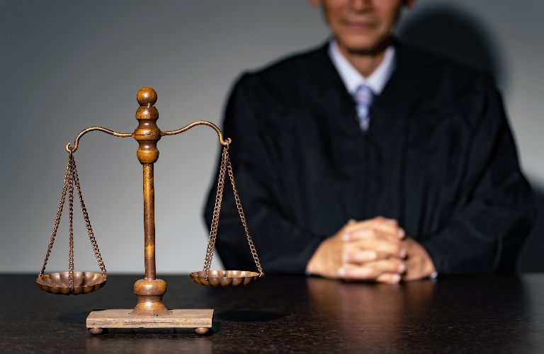 A man in a robe and a scale