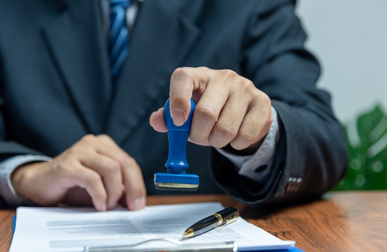 Man is putting stamp on the document