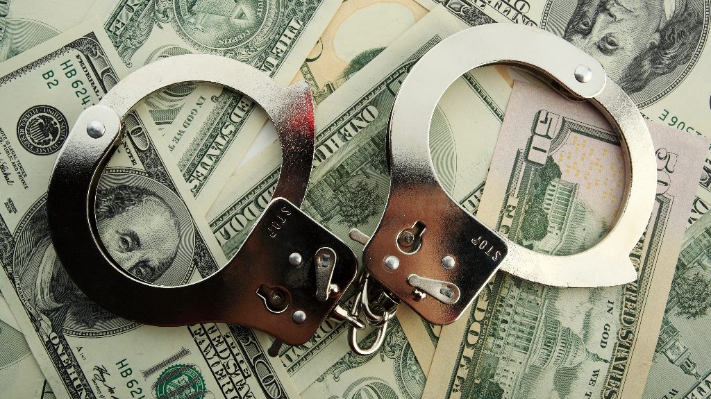 Silver handcuff and dollar