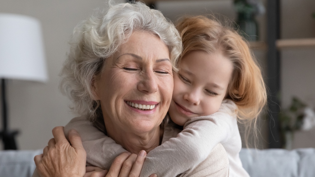 little girl hugs her grandmother