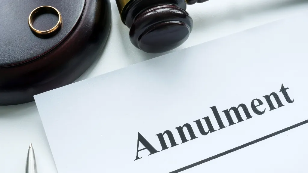 Close-up of a gold ring, judge’s gavel, and paper with “Annulment” text.